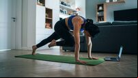 Woman practicing yoga at home