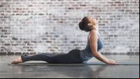 Young Woman Doing Yoga Meditation and Stretching Exercises