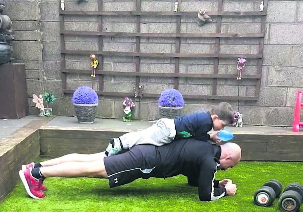 LEAN ON ME! Boxer Gary ‘Spike’ O’Sullivan training in the garden with his son LEAN ON ME! Boxer Gary ‘Spike’ O’Sullivan training in the garden with his son