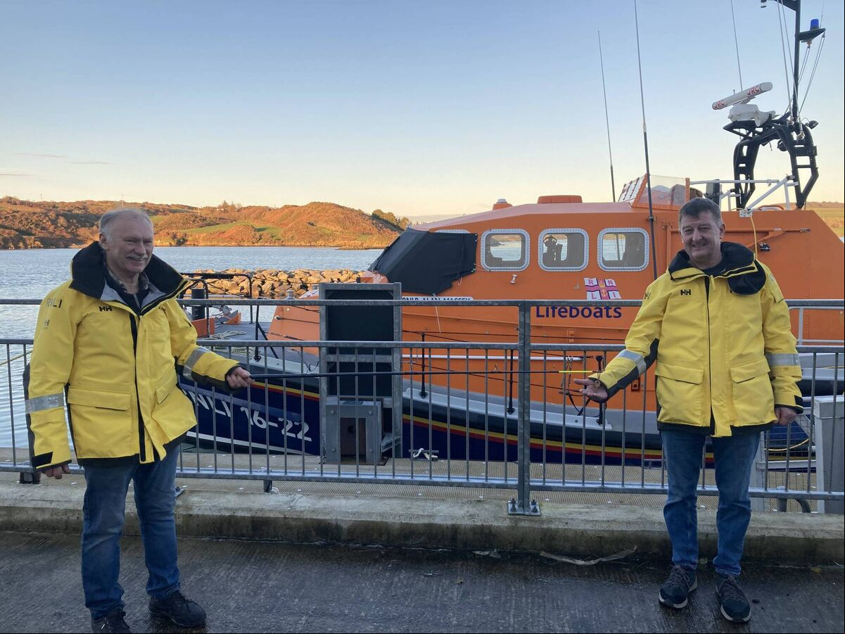 Socially distanced and by a fishing rod, Kieran Cotter hands over the lifeboat keys to Baltimore RNLI’s new Coxswain Aidan Bushe. Picture RNLI/Micheal Cottrell. Socially distanced and by a fishing rod, Kieran Cotter hands over the lifeboat keys to Baltimore RNLI’s new Coxswain Aidan Bushe. Picture RNLI/Micheal Cottrell.