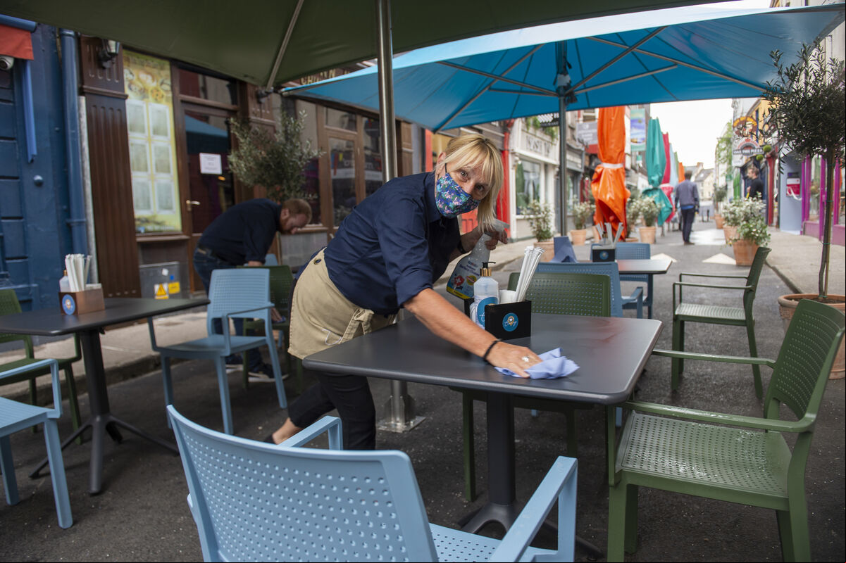 Margaret O'Riordan cleaning the tables at Clancy's Bar and Restaurant for today's June Bank Holiday reopening of outdoor hospitality on Princes Street, Cork. Picture Dan Linehan Margaret O'Riordan cleaning the tables at Clancy's Bar and Restaurant for today's June Bank Holiday reopening of outdoor hospitality on Princes Street, Cork. Picture Dan Linehan