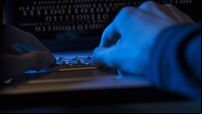 Computer hacker or programmer commits cyber attack using laptop.