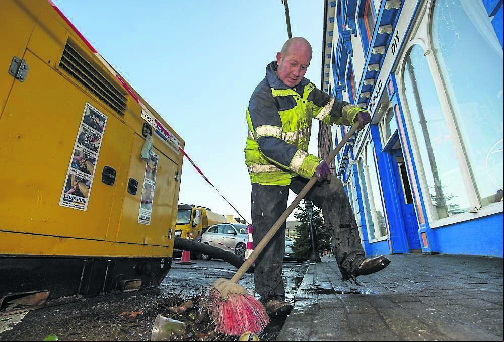 John Allen, of Cork County Council, brushing up the seaweed which was washed up through the drains during Storm Barra in Bantry last month. John Allen, of Cork County Council, brushing up the seaweed which was washed up through the drains during Storm Barra in Bantry last month.