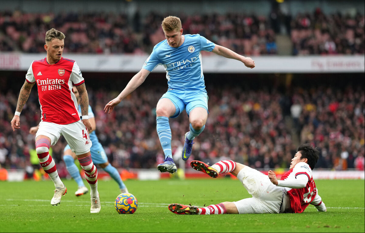 Manchester City's Kevin De Bruyne (centre) is tackled by Arsenal's Takehiro Tomiyasu (right) during their Premier League match at the Emirates Stadium. Mohamed Salah's pay claim at Liverpool would see him rise to a comparable wage as de Bruyne. Picture: John Walton/PA Wire Manchester City's Kevin De Bruyne (centre) is tackled by Arsenal's Takehiro Tomiyasu (right) during their Premier League match at the Emirates Stadium. Mohamed Salah's pay claim at Liverpool would see him rise to a comparable wage as de Bruyne. Picture: John Walton/PA Wire