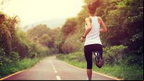 young fitness woman runner  running at forest trail