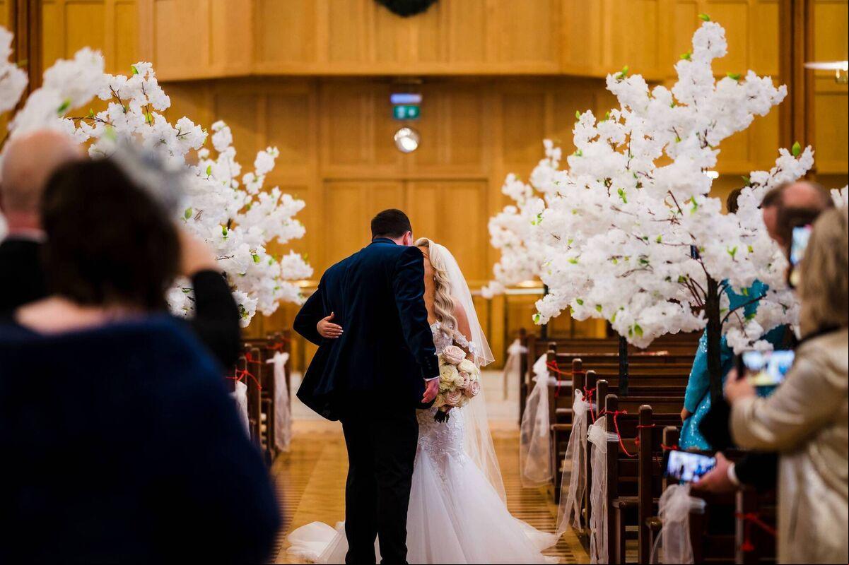 The couple meeting halfway down the aisle. The couple meeting halfway down the aisle.