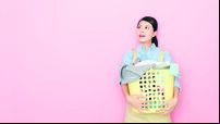 woman houseworker standing in pink background