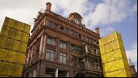 Facade of landmark Belfast city centre building begins to emerge