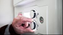 A pensioner adjusting the temperature control on his combi boiler. Redcar, UK. 26/5/2021. Photograph: Stuart Boulton.