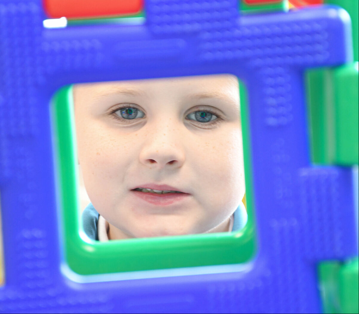 Fionn Buckley pictured looking through a tower of blocks on his first day. Fionn Buckley pictured looking through a tower of blocks on his first day.