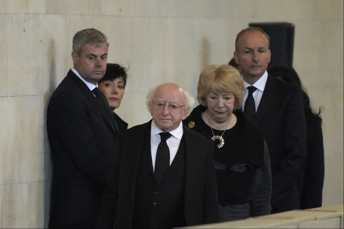 President of Ireland Michael D Higgins and his wife Sabina with Irish Taoiseach Micheal Martin pay their respects as they file past the coffin of Queen Elizabeth II. Photo: Markus Schreiber/PA Wire President of Ireland Michael D Higgins and his wife Sabina with Irish Taoiseach Micheal Martin pay their respects as they file past the coffin of Queen Elizabeth II. Photo: Markus Schreiber/PA Wire
