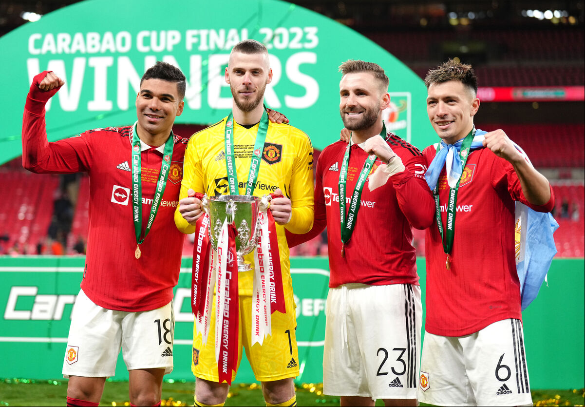 Manchester United's (left-right) Carlos Casemiro, David de Gea, Luke Shaw and Lisandro Martinez pose with the trophy after the Carabao Cup Final match at Wembley Stadium. Manchester United's (left-right) Carlos Casemiro, David de Gea, Luke Shaw and Lisandro Martinez pose with the trophy after the Carabao Cup Final match at Wembley Stadium.