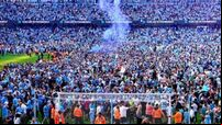 Manchester City players and fans celebrate step one of the treble
