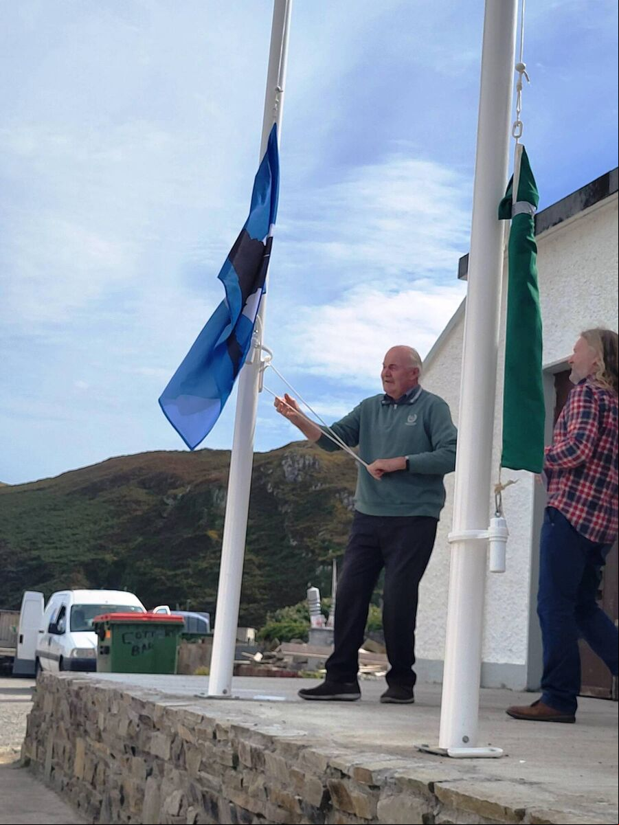 The Fastnet Flag being raised by Micheal O Ceadogain at Flags Day on the island. The Fastnet Flag being raised by Micheal O Ceadogain at Flags Day on the island.
