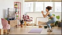 Young Woman Practicing Squats In Living Room