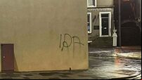Man arrested after graffiti sprayed near Troubles memorial