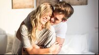 happy young couple relaxed at home on bed
