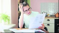 Indoor shot of young European Caucasian girl looking at financia
