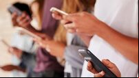 Teenage Students Using Digital Devices On College Campus