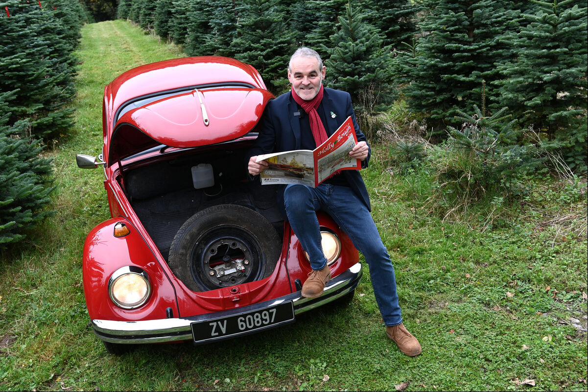 Holly Bough cover artist Peter Buckley with his red Volkswagen VW Beetle car which is featured in the artwork, pictured at Inniscarra Christmas Tree Farm.Pic Larry Cummins Holly Bough cover artist Peter Buckley with his red Volkswagen VW Beetle car which is featured in the artwork, pictured at Inniscarra Christmas Tree Farm.Pic Larry Cummins