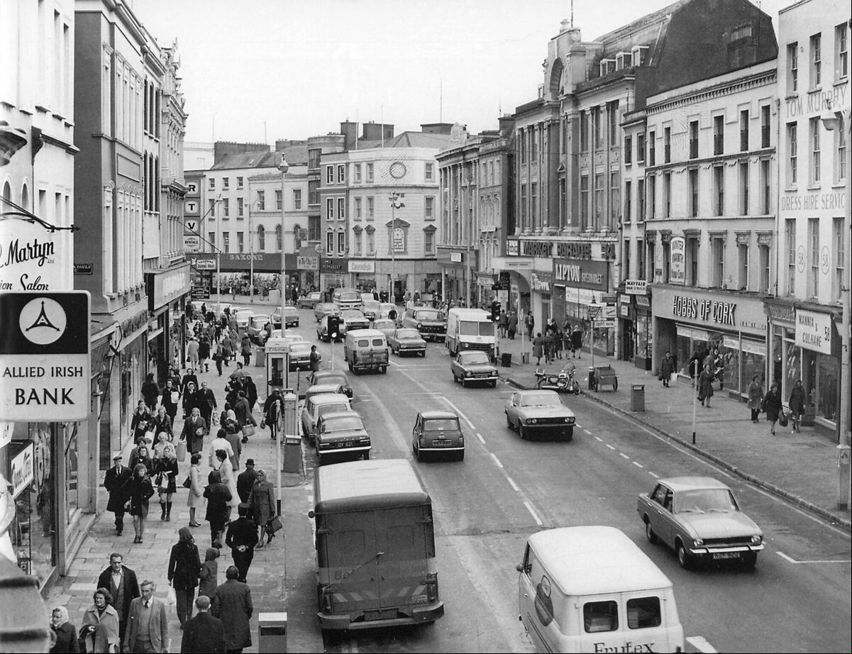 Patrick Street in the 1970s - you can see a phone kiosk on the pavement on the left. Patrick Street in the 1970s - you can see a phone kiosk on the pavement on the left.