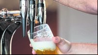 Barmans arms pulling a pint of beer
