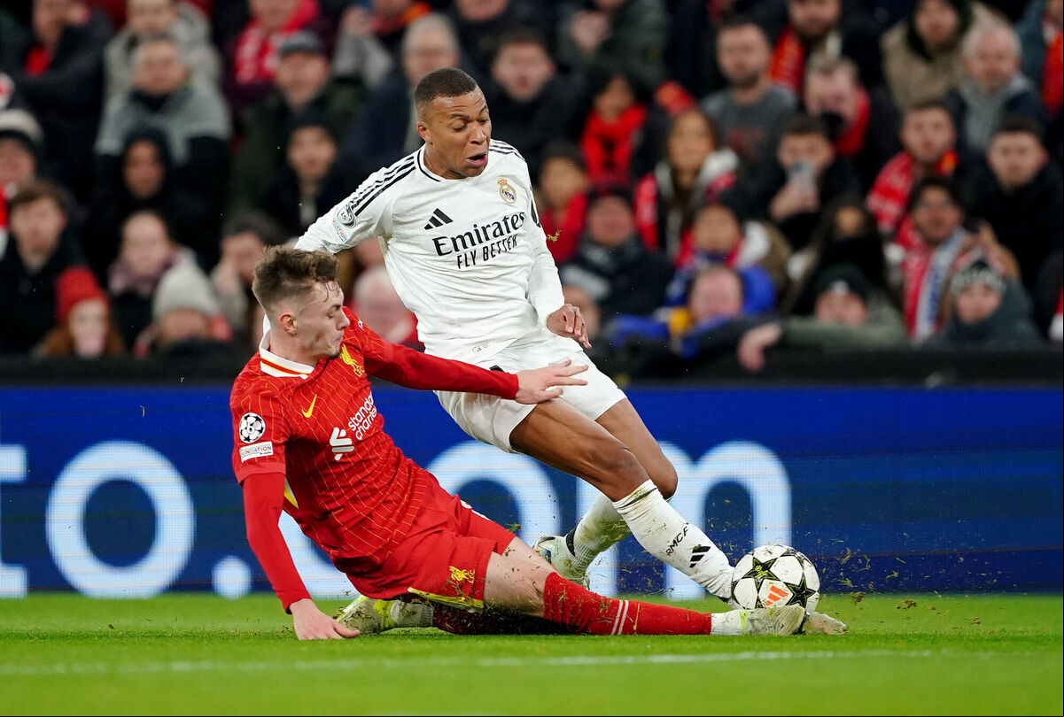 Liverpool's Conor Bradley clears out Real Madrid's Kylian Mbappe in the tackle during their UEFA Champions League match at Anfield, Liverpool, on Wednesday. Picture: Peter Byrne/PA Wire Liverpool's Conor Bradley clears out Real Madrid's Kylian Mbappe in the tackle during their UEFA Champions League match at Anfield, Liverpool, on Wednesday. Picture: Peter Byrne/PA Wire