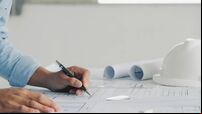 Close-up Of Engineer Hand Drawing Plan On Blue Print with architect equipment,architectural plan, sketching a construction proje