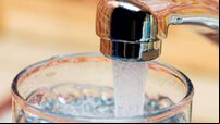 Filling up a glass with drinking water from kitchen tap