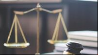 Scales of justice and Gavel on wooden table and Lawyer or Judge working with agreement in Courtroom, Justice and Law concept