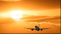 Plane is taking off at sunset