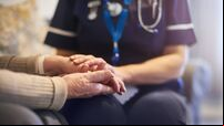 Nurse comforting patient at patient's home