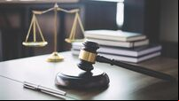 Scales of justice and Gavel on wooden table and Lawyer or Judge working with agreement in Courtroom, Justice and Law concept
