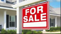 For Sale Real Estate Sign in Front of New House.