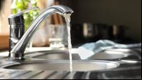 Water running from tap into kitchen sink